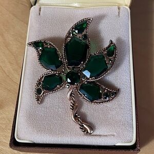 Vintage maple leaf brooch with emerald green glass pedals.